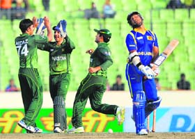 Pakistan's wicketkeeper Sarfraz Ahmed (2L) congratulates Aizaz Cheema (L) after the dismissal of Sri Lankas Kumar Sangakkara (R) at the Sher-e-Bangla Stadium in Dhaka on Thursday