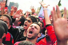 Supporters of Al-Ahly football club raise slogans during a march in Cairo to demand justice for the comrades killed in stadium violence last month.