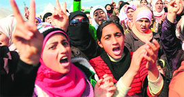 Syrian refugees and their children stage a demonstration against the President at a refugee camp in Turkey. 