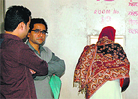 Patients stand in a queue at the GND Hospital to enquire about X-ray and deigital scan services in Amritsar.