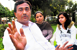 Anant Paul, an employee of Pepsi, talks about the Budget, as his wife Kavita and daughter Malvi look on in Mohali on Friday.