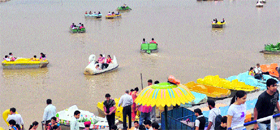 Visitors ride pedal boats at the Sukhna Lake on Friday.