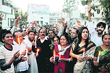 Supporters of Union Minister Harish Rawat take out a candlelight march in his support in Dehradun on Friday.