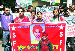 Workers of the Students Federation of India hold a demonstration against foreign investment in the education sector in front of the District Magistrates office in Dehradun on Friday