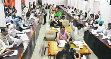Councillors raise their hands to unanimously pass the Ludhiana MC budget on Friday. 