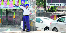 A traffic policeman manages traffic at SSSS Chowk in Amritsar.