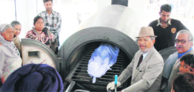 PS Bhatty from an NGO and Satpal Mahajan, president of Durgiana Mandir Committee perform the last rites before cremating an unclaimed body at LPG-run crematorium in Amritsar on Saturday.
