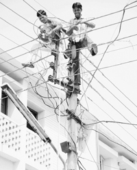 Workers work on an electricity pole at Sector 20 in Chandigarh