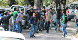 Student protesters throw stones during a clash between the SFI and the ABVP at HPU in Shimla 