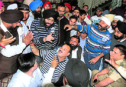 Shopkeepers argue with policemen at Naya Bazaar in Jalandhar on Saturday