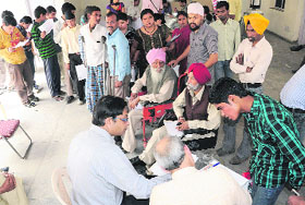 Visitors wait for their turn at a medical check-up camp for the physically challenged at Cheshire Homes in Sector 21, Chandigarh, on Sunday. 