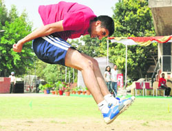 An athlete jumps during the event at GMCH-32 during an athletics meet at Sports Complex, Sector 46, Chandigarh, on Sunday. 