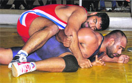 A wrestler tries to lift his opponent during the State Wrestling Championship at Skating Rink, Sector 10, Chandigarh, on Sunday.
