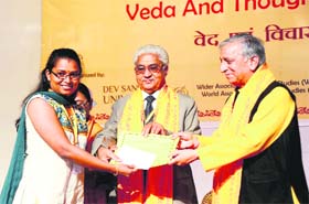 A research scholar is felicitated on the concluding day of an international conference at Dev Sanskriti Vishwavidyalaya in Haridwar on Sunday