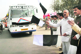 BJP state president Shamsher Singh Manhas flags off a bus carrying West Pakistan refugees from Jammu to New Delhi on Sunday. 