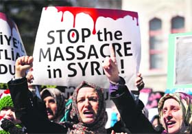 Demonstrators shout slogans during a protest against Syria's President Bashar Al-Assad in front of the Beyazit mosque in Istanbul on Sunday