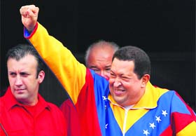 Back in action: Venezuela's President Hugo Chavez greets supporters as he attends a ceremony at Miraflores Palace in Caracas on Saturday