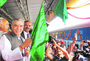 Union minister Pawan Kumar Bansal flags off the first train to Bandra at the Chandigarh railway station on Sunday. 