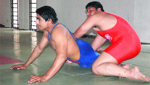 A wrestler tries to hold his position during the finals of Junior and Sub-Junior Wrestling Championship at Sector 42 in Chandigarh on Monday. 