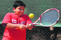 A player returns a shot during a tennis match of U-12 at Sector 11, Chandigarh, on Monday.