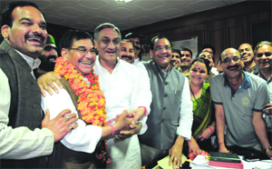 Congress nominee for the Rajya Sabha Mahendra Singh Mahra arrives with Chief Minister Vijay Bahuguna and other Congress leaders for filing nomination papers at the Uttarakhand Assembly in Dehradun on Monday