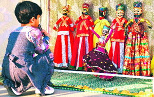 A girl watches a puppet show at a mall in Gurgaon. 