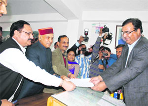 (From left) JP Nadda, national BJP general secretary, PK Dhumal, Chief Minister, and Satpal Satti, state BJP president, during the filing of the nomination papers for the Rajya Sabha at the Vidhan Sabha in Shimla on Monday. 