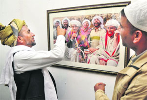 Gujjars appreciate a photograph during an exhibition in Jammu on Monday.