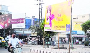 An advertising board put up in the Aarti Chowk area, Ludhiana, on Monday.