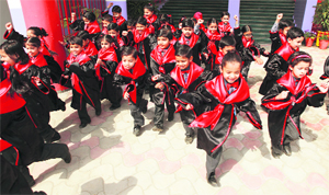 Children come out of a hall after their graduation ceremony at BCM School in Ludhiana