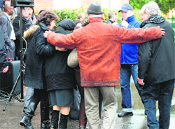 Bereaved family members leave the Jewish school in Toulouse