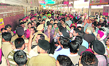 Police officers pacify agitating passengers, waiting for the resumption of rail traffic, at railway station in Amritsar on Tuesday.