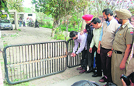 Sushant Bhatia, superintendent, house tax department, seals Punjab Water Supply and Sewerage Board office at Ranjit Avenue in Amritsar on Tuesday.