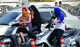 Girls riding two-wheelers with covered faces remained a normal feature in the city.