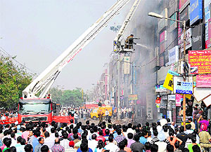 A skylift firetender from Chandigarh douses flames at a showroom in Sector 11, Panchkula, on Tuesday