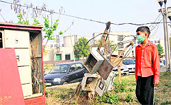 A teenage patient walks past live wires in an open area of the PGI market near the College of Nursing in Chandigarh on Monday