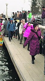 Tourists move to safer places after the wind storm in Srinagar