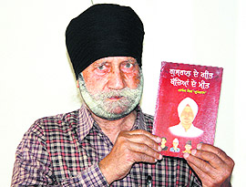Harbans Lal Gurjal shows his book on poems