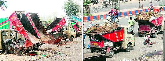 Garbage-lifting vehicles lie in a workshop for repair; and (right) garbage being carried by vehicles on the road without lids on trolleys in Amritsar