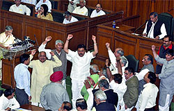 Chief Minister Sheila Dikshit presents the vote-on-account in the Delhi Assembly as members of the opposition parties shout slogans on Wednesday