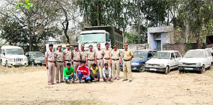 The gang members with the looted vehicles in police custody at Sonepat