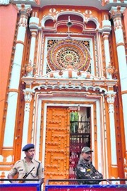Police personnel stand guard outside Raghunath Temple in Jammu on Wednesday.