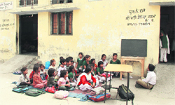 Students sit on uneven ground due to lack of classrooms and benches in Jalandhar