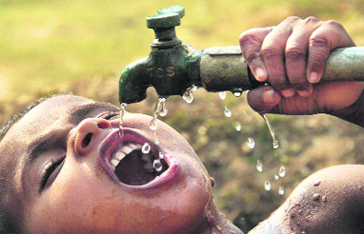 A boy drinks water from a public tap in Agartala on Wednesday