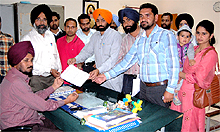 Teachers submit a memorandum to the primary block officer Darshan Singh Jeeda at his office in Bathinda on Thursday;