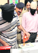 An accused shows how he made fake rubber stamps using a chemical to policemen in Chandigarh on Thursday.
