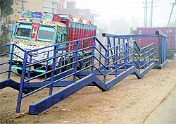 Material for constructing a foot overbridge lying in the open for the past several months at Doraha