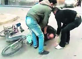 A wounded man being taken away after he was allegedly shot by a Syrian forces sniper