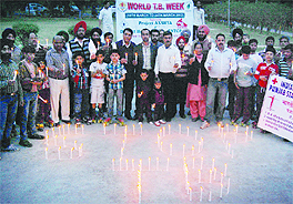 People participate in a candle march to create awareness about tuberculosis at Company Bagh in Amritsar on Friday.