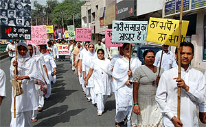 People participate in a march organised to protest against female foeticide and to spread awareness against the menace that has reached an alarming proportion in the state, at the Mall Road in Bathinda on Friday